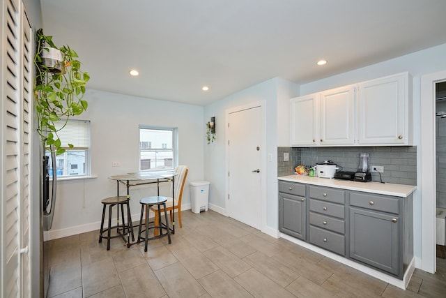 1931 N Leamington Ave, Chicago, IL 60639 - kitchen featuring gray cabinets, decorative backsplash, white cabinets, light countertops, and recessed lighting