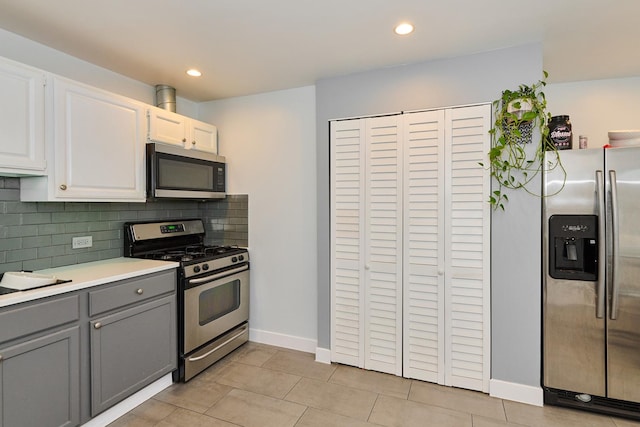 1931 N Leamington Ave, Chicago, IL 60639 - kitchen with stainless steel appliances, gray cabinetry, backsplash, light countertops, and white cabinetry
