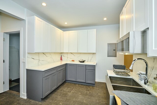 1931 N Leamington Ave, Chicago, IL 60639 - kitchen with gray cabinets, decorative backsplash, recessed lighting, stainless steel microwave, and electric panel