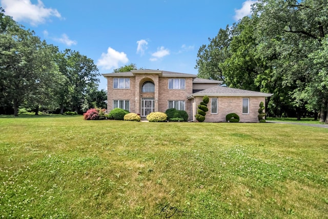 15516 Frontage Rd, Markham, IL 60428 - colonial house featuring a front yard and brick siding