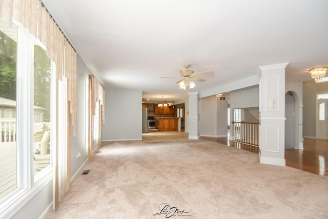 15516 Frontage Rd, Markham, IL 60428 - unfurnished living room with a chandelier, light carpet, ceiling fan, and arched walkways