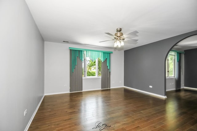 15516 Frontage Rd, Markham, IL 60428 - spare room featuring arched walkways, plenty of natural light, ceiling fan, and wood finished floors