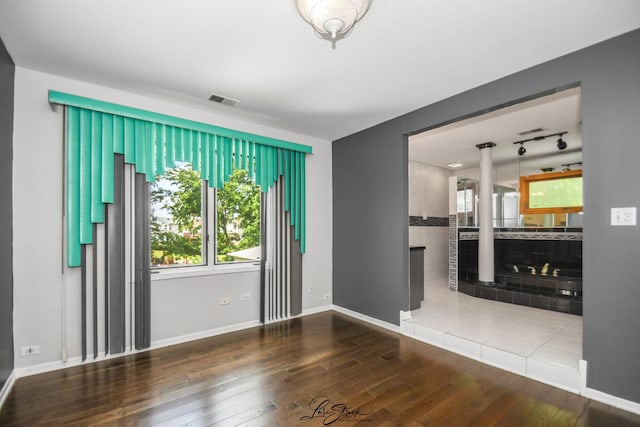 15516 Frontage Rd, Markham, IL 60428 - unfurnished living room with ornate columns and hardwood / wood-style floors