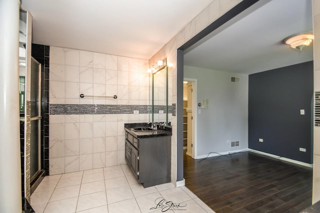 15516 Frontage Rd, Markham, IL 60428 - bathroom with vanity, tile walls, wood finished floors, and tiled shower