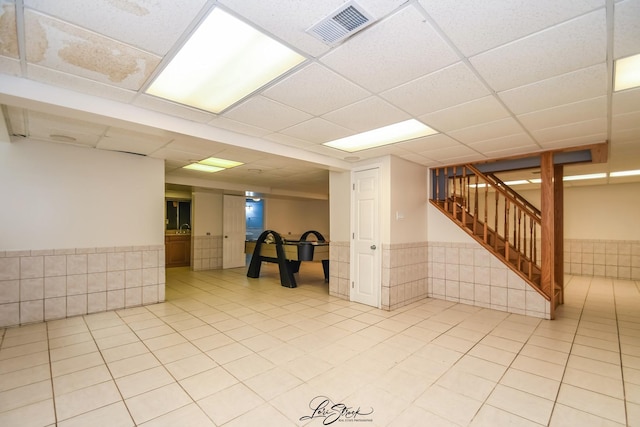 15516 Frontage Rd, Markham, IL 60428 - below grade area featuring a wainscoted wall, stairway, a drop ceiling, and light tile patterned floors
