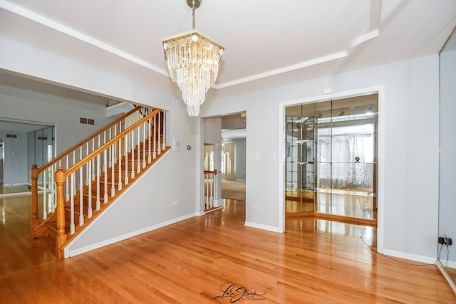 15516 Frontage Rd, Markham, IL 60428 - interior space featuring a chandelier, stairway, wood finished floors, and healthy amount of natural light