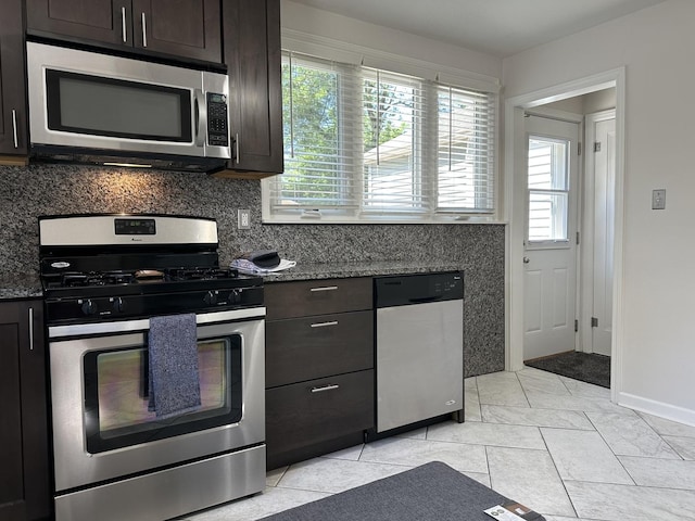 652 Beckman Dr, Kankakee, IL 60901 - kitchen with stainless steel appliances, plenty of natural light, dark brown cabinetry, and tasteful backsplash