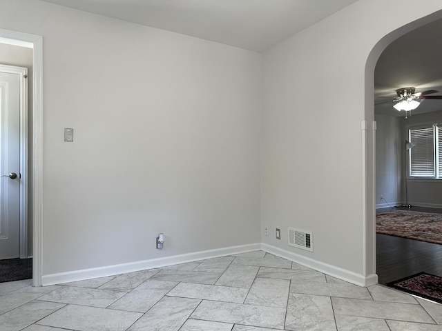 652 Beckman Dr, Kankakee, IL 60901 - empty room with arched walkways, a ceiling fan, and light marble finish flooring