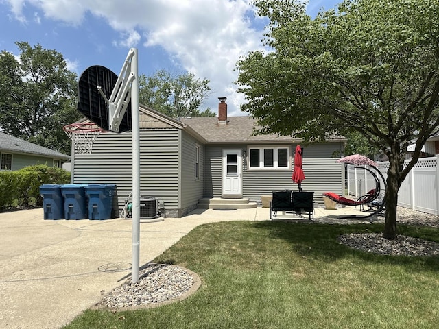 652 Beckman Dr, Kankakee, IL 60901 - back of house with entry steps, a patio area, a chimney, and a shingled roof