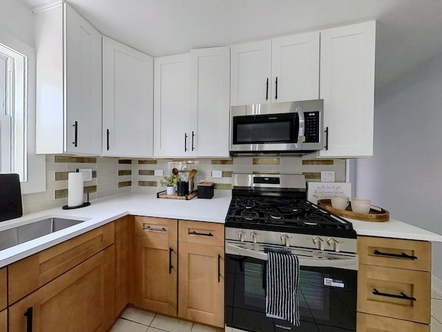 2808 W 84th St, Chicago, IL 60652 - kitchen featuring stainless steel appliances, decorative backsplash, and light countertops