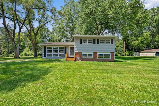 4421 Elmleaf Dr, Mchenry, IL 60051 - tri-level home with a front lawn, brick siding, entry steps, and a sunroom