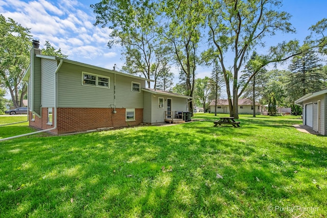 4421 Elmleaf Dr, Mchenry, IL 60051 - rear view of property featuring a chimney, brick siding, and a lawn