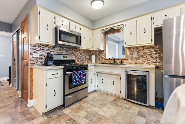 13635 W Ironwood Cir, Homer Glen, IL 60491 - kitchen featuring appliances with stainless steel finishes, wine cooler, stone tile floors, and light countertops