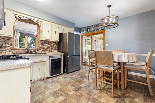 13635 W Ironwood Cir, Homer Glen, IL 60491 - kitchen featuring beverage cooler, stainless steel appliances, stone tile floors, and tasteful backsplash