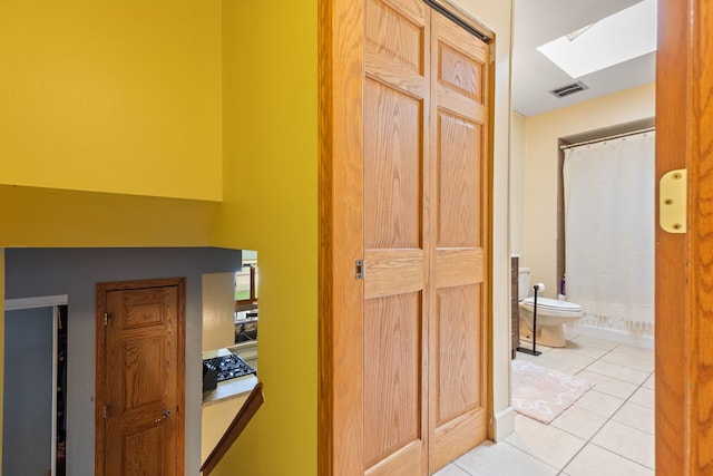 13635 W Ironwood Cir, Homer Glen, IL 60491 - corridor featuring light tile patterned floors and a skylight
