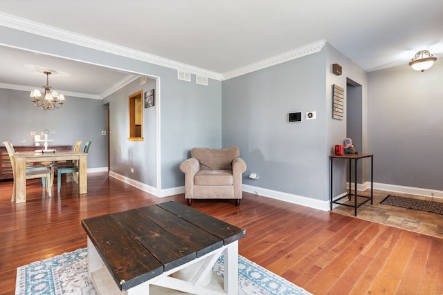 13635 W Ironwood Cir, Homer Glen, IL 60491 - living area with wood finished floors, a chandelier, and ornamental molding