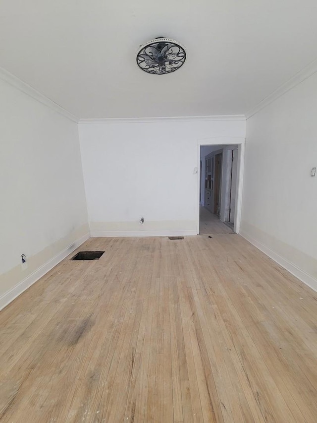 2854 S Central Park Ave, Chicago, IL 60623 - spare room with light wood-style flooring and ornamental molding