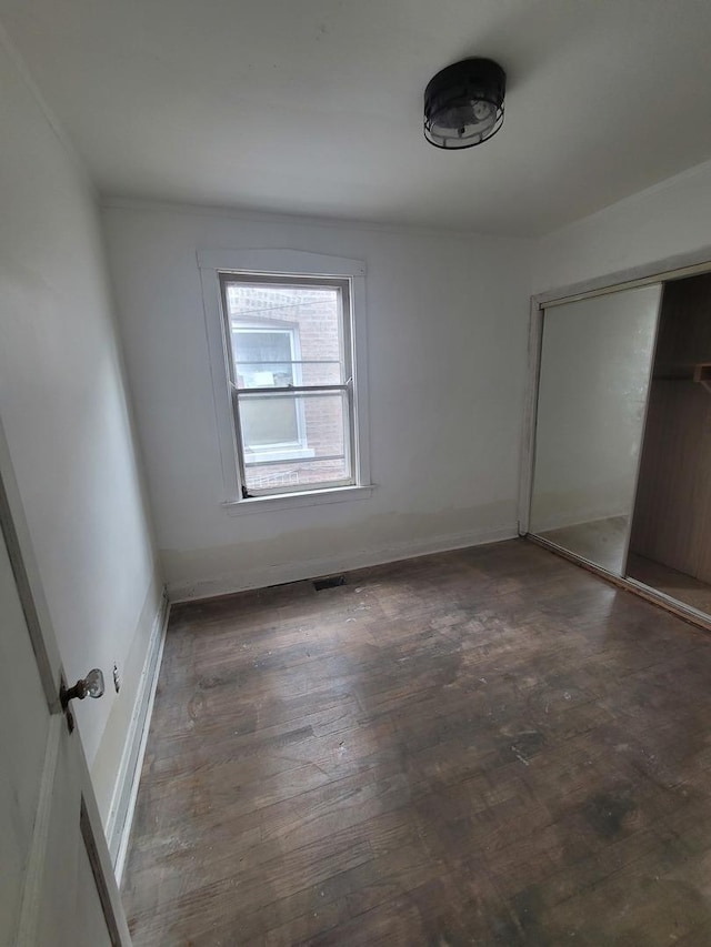 2854 S Central Park Ave, Chicago, IL 60623 - unfurnished bedroom featuring wood finished floors and a closet
