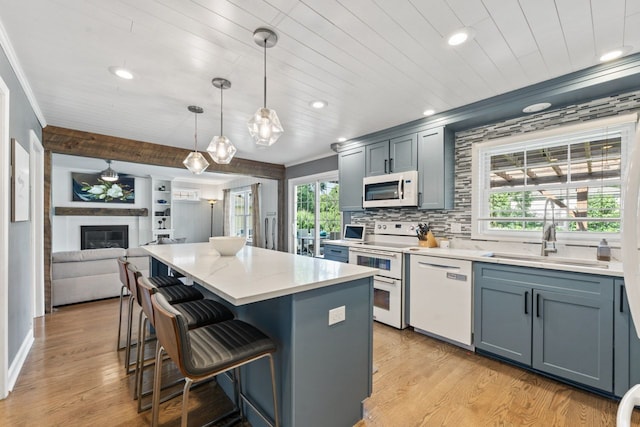 1507 Eton Ln, Naperville, IL 60565 - kitchen featuring white appliances, light wood finished floors, a kitchen island, recessed lighting, and light countertops