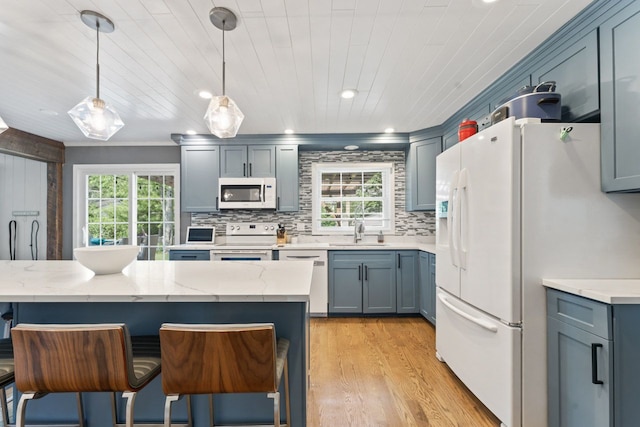 1507 Eton Ln, Naperville, IL 60565 - kitchen with white appliances, light wood finished floors, a kitchen bar, tasteful backsplash, and recessed lighting