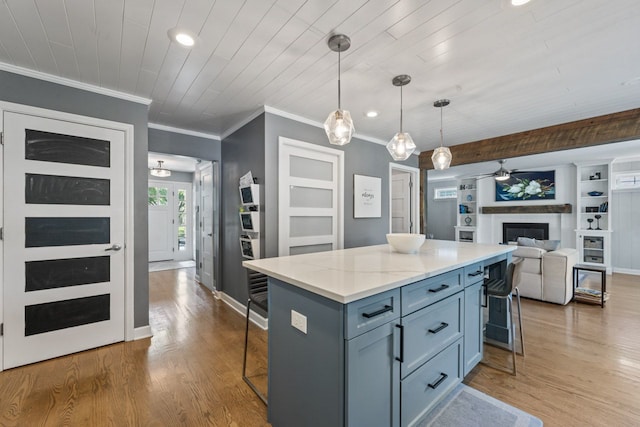 1507 Eton Ln, Naperville, IL 60565 - kitchen with a breakfast bar area, a kitchen island, wood finished floors, ornamental molding, and open floor plan
