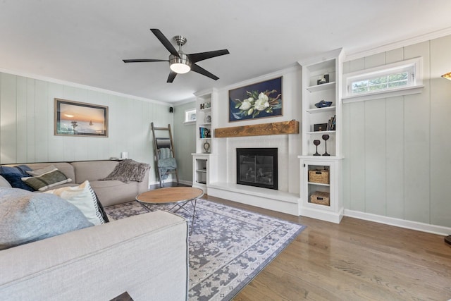 1507 Eton Ln, Naperville, IL 60565 - living area featuring ornamental molding, ceiling fan, wood finished floors, a glass covered fireplace, and built in shelves