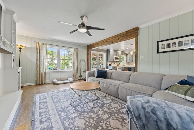 1507 Eton Ln, Naperville, IL 60565 - living room with light wood-style flooring, ceiling fan, and ornamental molding