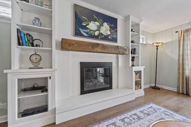 1507 Eton Ln, Naperville, IL 60565 - unfurnished living room featuring wood finished floors, a brick fireplace, and built in shelves