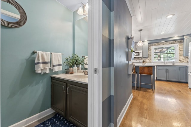 1507 Eton Ln, Naperville, IL 60565 - bathroom featuring wood finished floors, two vanities, and backsplash