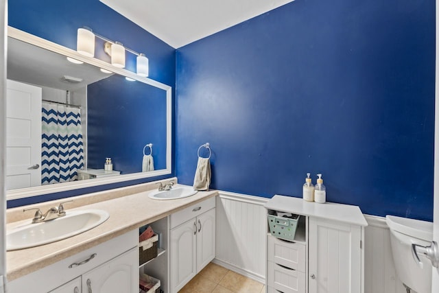 1507 Eton Ln, Naperville, IL 60565 - bathroom with wainscoting, double vanity, tile patterned floors, and a shower with curtain