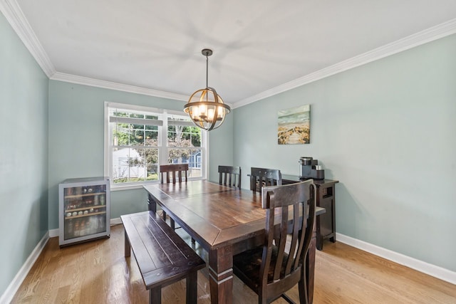 1507 Eton Ln, Naperville, IL 60565 - dining area with wine cooler, a chandelier, light wood finished floors, and ornamental molding