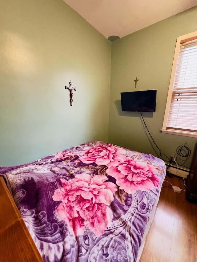 4817 W 28th St, Cicero, IL 60804 - bedroom with wood finished floors, vaulted ceiling, and a baseboard heating unit
