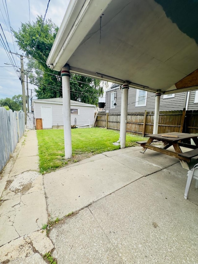 4817 W 28th St, Cicero, IL 60804 - fenced backyard with a patio area, a carport, and an outbuilding