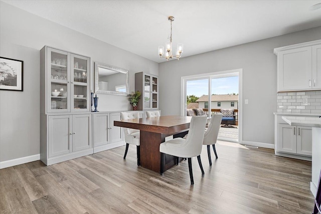 507 Raef Rd, Downs, IL 61736 - dining room featuring light wood-style flooring and a chandelier
