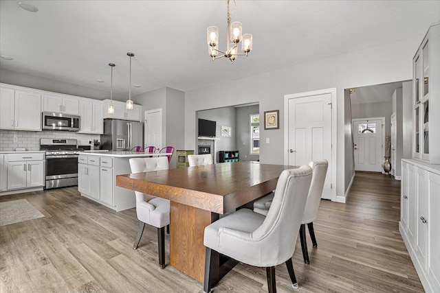 507 Raef Rd, Downs, IL 61736 - dining area with a chandelier and light wood-style flooring