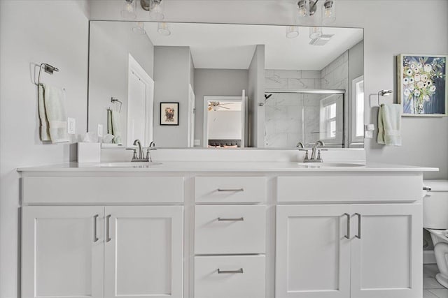 507 Raef Rd, Downs, IL 61736 - bathroom featuring double vanity, a shower stall, and a ceiling fan
