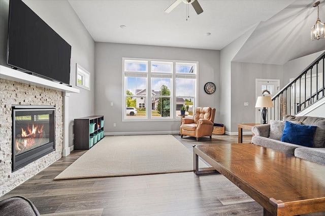 507 Raef Rd, Downs, IL 61736 - living area with stairs, a ceiling fan, wood finished floors, and a fireplace