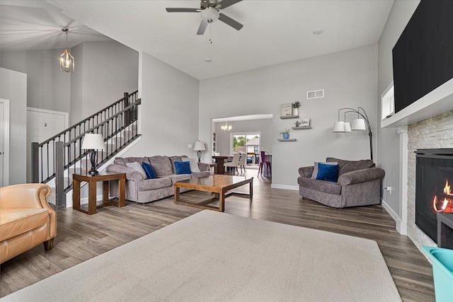 507 Raef Rd, Downs, IL 61736 - living room with high vaulted ceiling, a chandelier, a fireplace, wood finished floors, and a ceiling fan