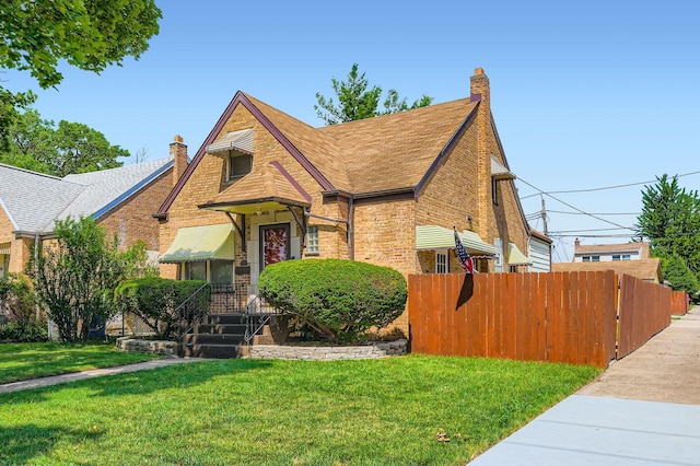 11341 S Spaulding Ave, Chicago, IL 60655 - tudor house featuring brick siding, a chimney, and a shingled roof