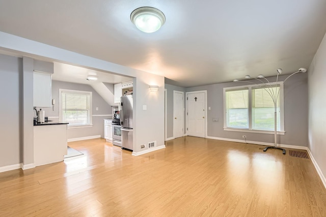 11341 S Spaulding Ave, Chicago, IL 60655 - unfurnished living room featuring light wood-type flooring and healthy amount of natural light