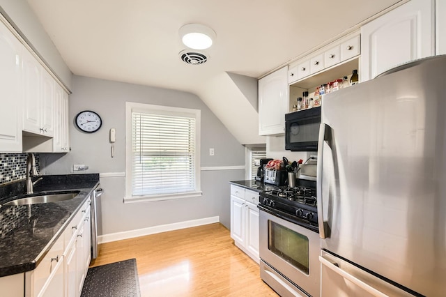 11341 S Spaulding Ave, Chicago, IL 60655 - kitchen featuring appliances with stainless steel finishes, white cabinetry, light wood-type flooring, dark stone countertops, and lofted ceiling
