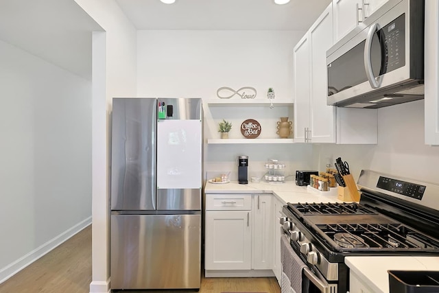 2355 W Congress Pkwy Unit 1, Chicago, IL 60612 - kitchen featuring stainless steel appliances, light wood-style floors, white cabinets, open shelves, and recessed lighting