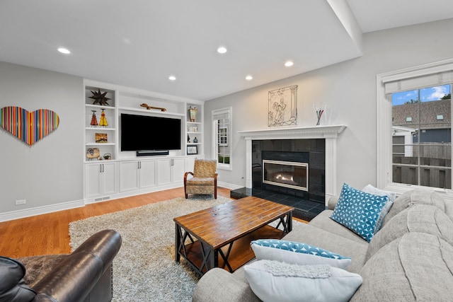 2210 Center Ave, Northbrook, IL 60062 - living room featuring a tiled fireplace, wood finished floors, recessed lighting, and built in features