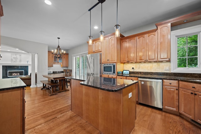 2210 Center Ave, Northbrook, IL 60062 - kitchen featuring stainless steel appliances, light wood finished floors, a center island, dark stone countertops, and recessed lighting