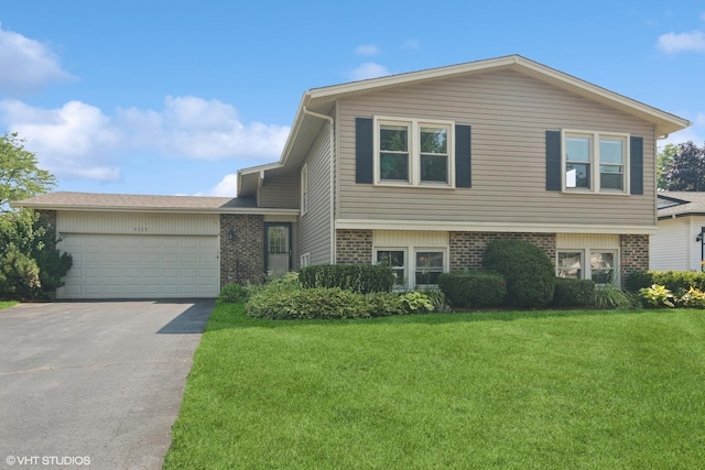 4325 Sandlewood Ln, Hoffman Estates, IL 60192 - view of front of house with brick siding, a front yard, driveway, and an attached garage