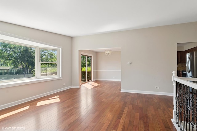 4325 Sandlewood Ln, Hoffman Estates, IL 60192 - unfurnished living room featuring a chandelier and dark wood finished floors