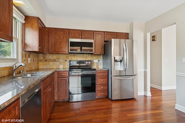 4325 Sandlewood Ln, Hoffman Estates, IL 60192 - kitchen featuring stainless steel appliances, stone countertops, dark wood-style flooring, tasteful backsplash, and brown cabinets