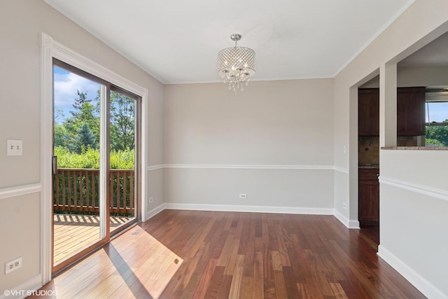 4325 Sandlewood Ln, Hoffman Estates, IL 60192 - spare room with plenty of natural light, a chandelier, dark wood-type flooring, and crown molding