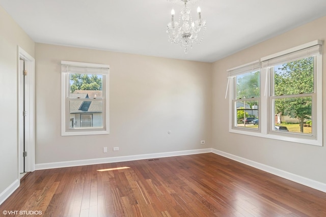 4325 Sandlewood Ln, Hoffman Estates, IL 60192 - empty room with a chandelier, healthy amount of natural light, and wood-type flooring