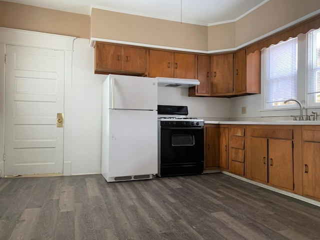 132 S Mchenry Ave, Crystal Lake, IL 60014 - kitchen with freestanding refrigerator, gas range oven, brown cabinets, and dark wood-style floors